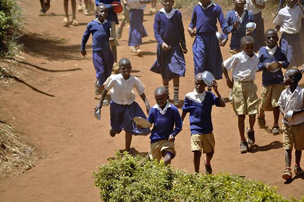 Schoolkids running the luch break