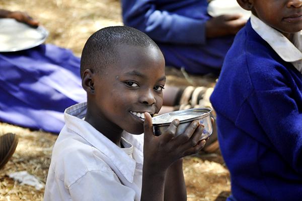 Schoolchild from Tanzania is eating her lunch