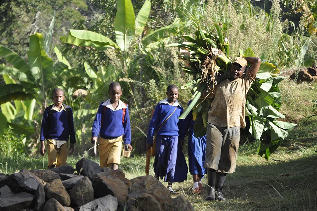 farmer with schoolkids on the way to the school